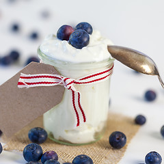 Image showing Jar of clotted cream or yogurt with blueberries