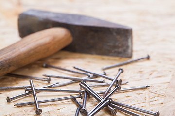 Image showing Mallet with nails and planks of new wood