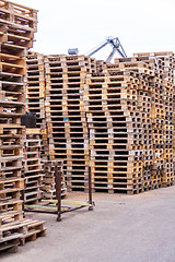 Image showing Stacks of old wooden pallets in a yard