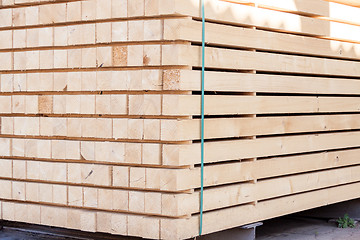 Image showing Wooden panels stored inside a warehouse