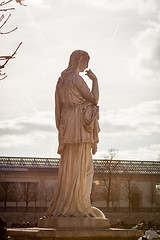 Image showing Bird perched on an ancient stone statue