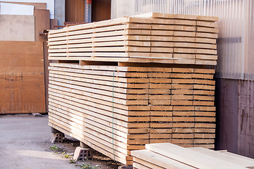 Image showing Wooden panels stored inside a warehouse