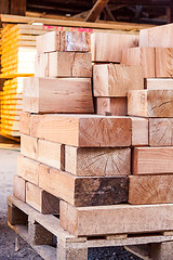 Image showing Wooden panels stored inside a warehouse