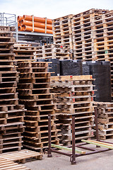 Image showing Stacks of old wooden pallets in a yard