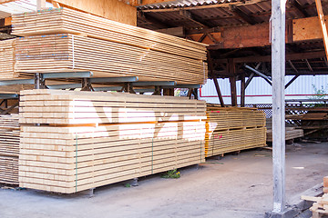 Image showing Wooden panels stored inside a warehouse