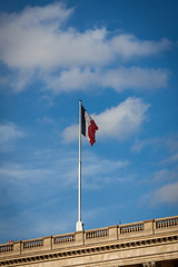 Image showing Flag of France fluttering under a serene blue sky