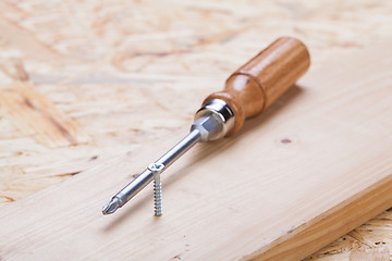 Image showing Phillips head screwdriver and wood screws