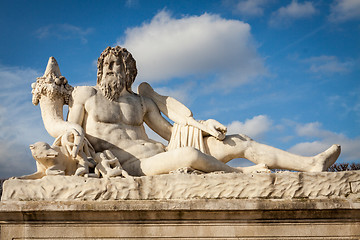 Image showing Bird perched on an ancient stone statue