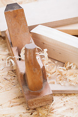 Image showing Handheld wood plane with wood shavings