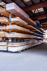 Image showing Wooden panels stored inside a warehouse