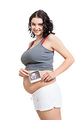 Image showing Pregnant woman displaying a prenatal ultrasound