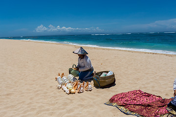 Image showing Woman selling seashells on a beach in Bali