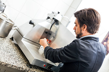 Image showing Commercial cook or chef slicing cold meat