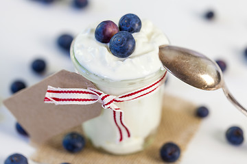 Image showing Jar of clotted cream or yogurt with blueberries