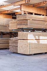 Image showing Wooden panels stored inside a warehouse