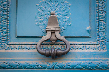 Image showing Brass door handle on a colorful blue door