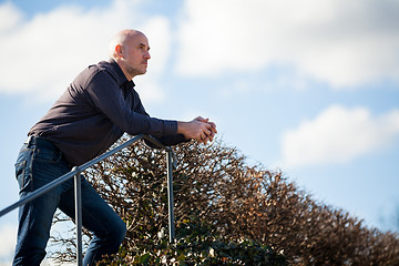 Image showing Thoughtful man sitting on a flight of steps