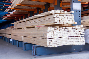 Image showing Wooden panels stored inside a warehouse