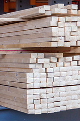 Image showing Wooden panels stored inside a warehouse