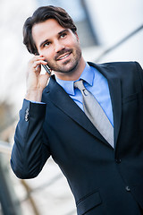 Image showing Businessman listening to a call on his mobile