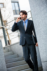 Image showing Businessman listening to a call on his mobile