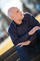 Image showing Thoughtful man sitting on a flight of steps