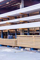 Image showing Wooden panels stored inside a warehouse