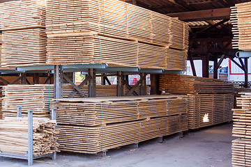 Image showing Wooden panels stored inside a warehouse