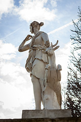 Image showing Bird perched on an ancient stone statue