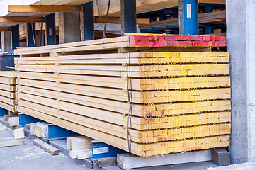 Image showing Wooden panels stored inside a warehouse