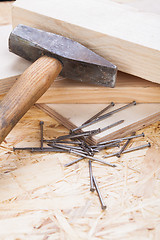 Image showing Mallet with nails and planks of new wood