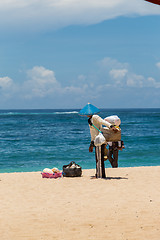 Image showing Woman selling seashells on a beach in Bali