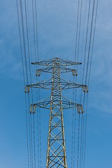 Image showing Large electric pylon with blue sky