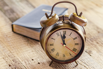 Image showing Clock and Bible on wood