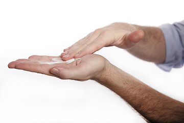 Image showing Man uses hand cream