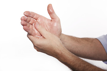 Image showing Man uses hand cream