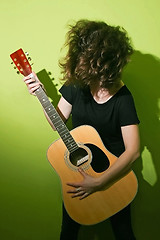 Image showing Guitar woman tousling hair
