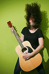 Image showing Guitar woman shaking hair