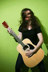 Image showing Woman holding rock guitar