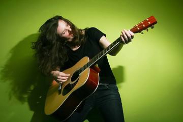 Image showing Young woman playing guitar