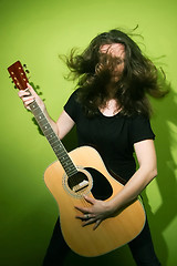 Image showing Guitar woman with tousled hair