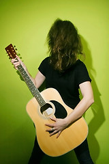 Image showing Woman shaking hair with guitar