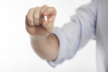 Image showing Man in blue shirt takes pills