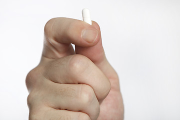 Image showing Man in blue shirt takes pills