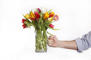 Image showing A hand full of colorful tulips