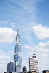 Image showing Aircraft flying high above The Shard in London, England