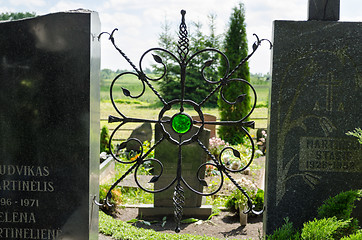 Image showing brass ornament with shiny green stone in cemetery 