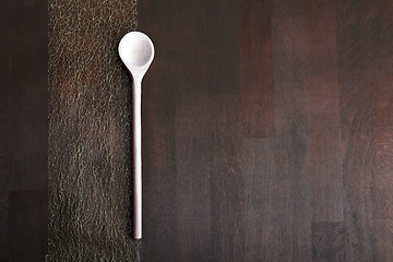 Image showing Wooden spoon on dark background