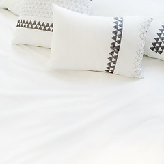 Image showing Elegant white bed linen with pillows