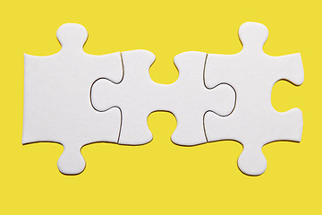 Image showing White puzzle piece on yellow background